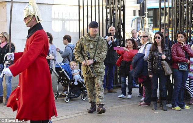 Armed guards seen on the streets of Westminster as military boosts security in the wake of Canadian parliament attack