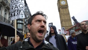 Demonstrators march through London to protest British air strikes against Islamic State in Iraq