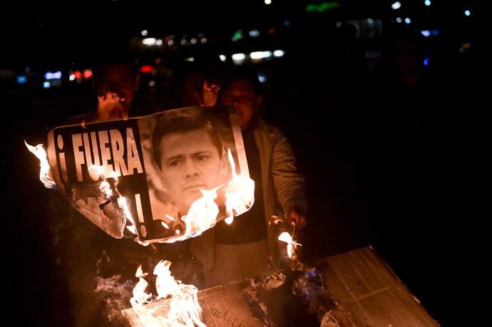 Mexicans march against president as fresh graves discovered
