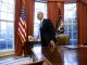 President Barack Obama gets up from his desk after signing the memorandum