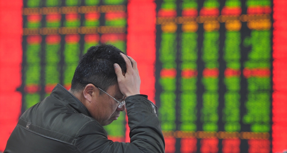 A stock investor gestures as he checks share prices at a securities firm in Fuyang, east China's Anhui province on January 19, 2015. Chinese shares plunged on January 19 after regulators punished several brokerages for violating rules for margin trading business, which has fuelled an extended market rally, analysts said. AFP PHOTO CHINA OUT (Photo credit should read STR/AFP/Getty Images)