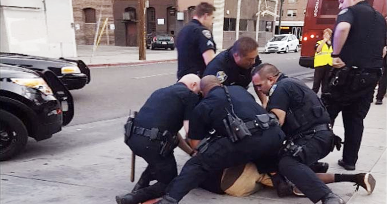 Video of nine LA cops slamming unnarmed black teenager to ground for 'jaywalking'