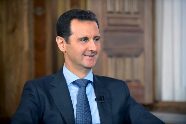 Syria's President Bashar al-Assad answers questions during an interview with al-Manar's journalist Amro Nassef, in Damascus