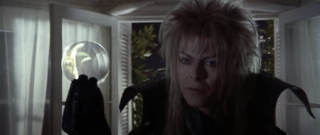 Jareth offering Sarah “gifts” represented by the crystal ball 
