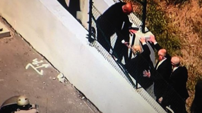 Donald Trump forced to jump fence at California rally to escape violent mob of protestors