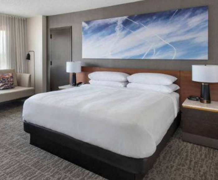 High-end hotel chain JW Marriott has been accused of attempting to normalize the chemtrail agenda by placing artworks on their walls featuring chemtrails sprayed on blue skies.