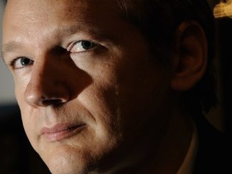 Julian Assange has warned that a Clinton White House will see a merger between the private power of corporations and the military might of the state.