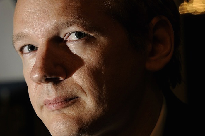 Julian Assange has warned that a Clinton White House will see a merger between the private power of corporations and the military might of the state.