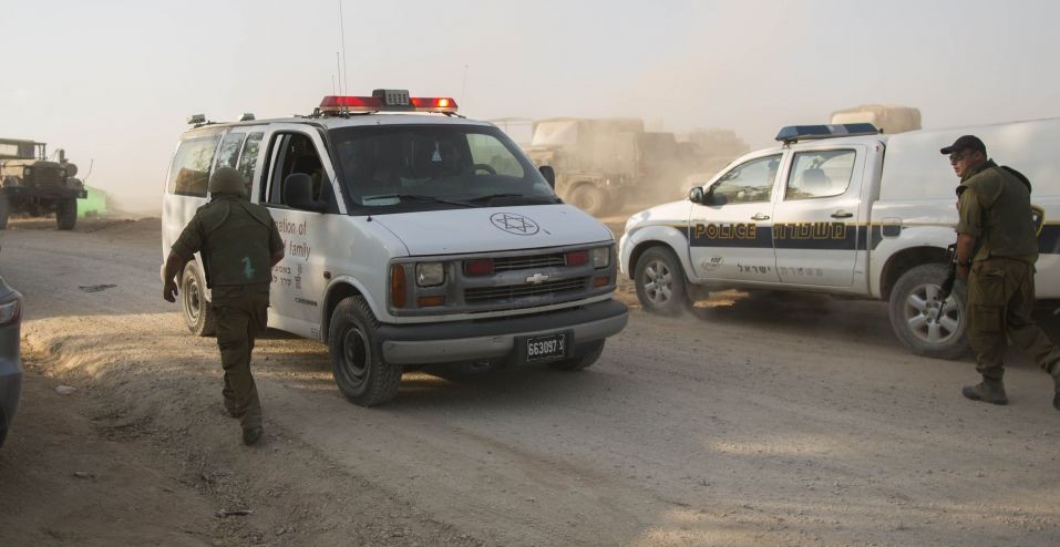 Israeli Prime Minister Benjamin Netanyahu, third right, visits a militant wounded in Syria at a field hospital in northern Israel, February 2014.