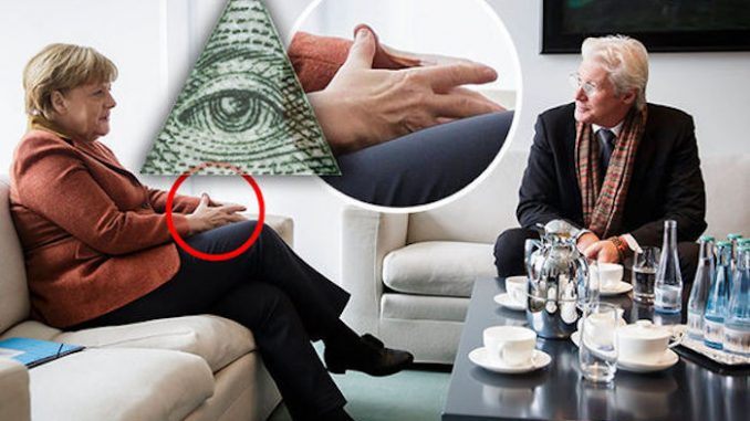 Angela Merkel has been caught on camera flashing Illuminati hand sign at Richard Gere in Berlin, and eye-witnesses claim the Hollywood actor responded by flashing the sign back at her.