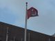 Leftist protestors stormed a government building in Minnesota on Monday, lowering and partially burning an American flag before hoisting an Antifa flag in its place.