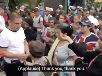 Men caught handing caravan migrants cash at border