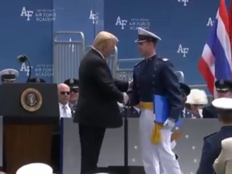 President Trump stands, salutes and shakes hands with 900 cadets