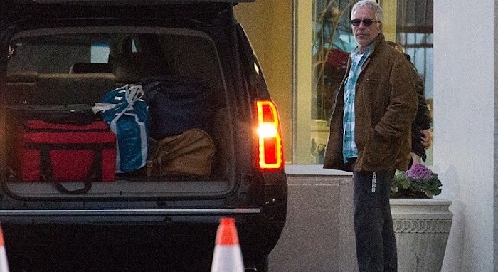 Authorities found a foreign passport with Jeffrey Epstein's photo and a false name in a "locked safe" during a search of his New York home.