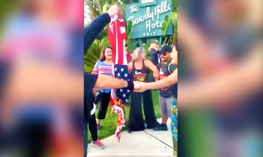 Anti-Trump protestors burned an American flag amid the arrival of President Donald Trump in Los Angeles for a fundraising event.
