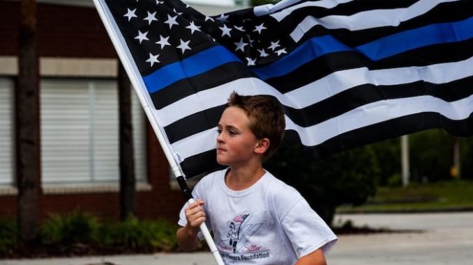 A determined 11-year-old boy has been running a mile for every First Responder that has fallen in the line of duty and donating money to the families of the fallen.