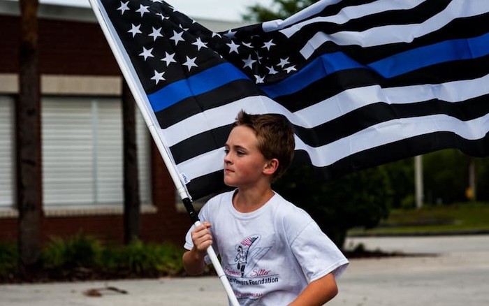 A determined 11-year-old boy has been running a mile for every First Responder that has fallen in the line of duty and donating money to the families of the fallen.