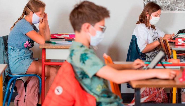 Head of Oxford University vaccine team admits masks and social distancing measures will continue until next summer.