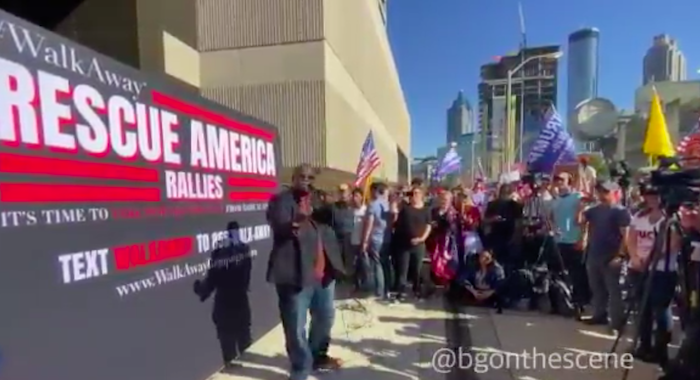 Large crowds gather outside CNN HQ in Atlanta chanting 'CNN sucks'