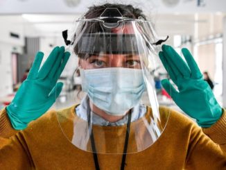 Experts want Americans to wear three masks