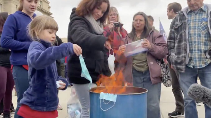 Families burn masks outside state Capitol