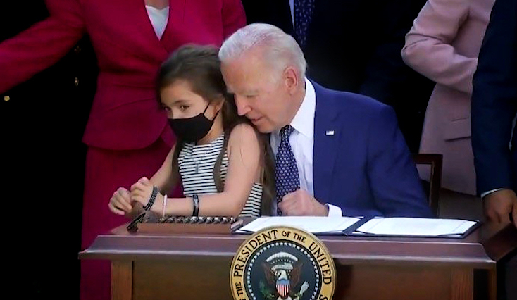 President Joe Biden grabs little girl during bill signing at the White House