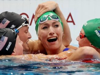 Olympic swimmer with 'glory to god' cap wins gold, smashing world records