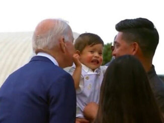 Baby cries out in terror as Joe Biden leans in for his signature sniff and kiss