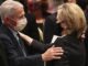 Dr. Anthony Fauci embraces Hillary Clinton at funeral