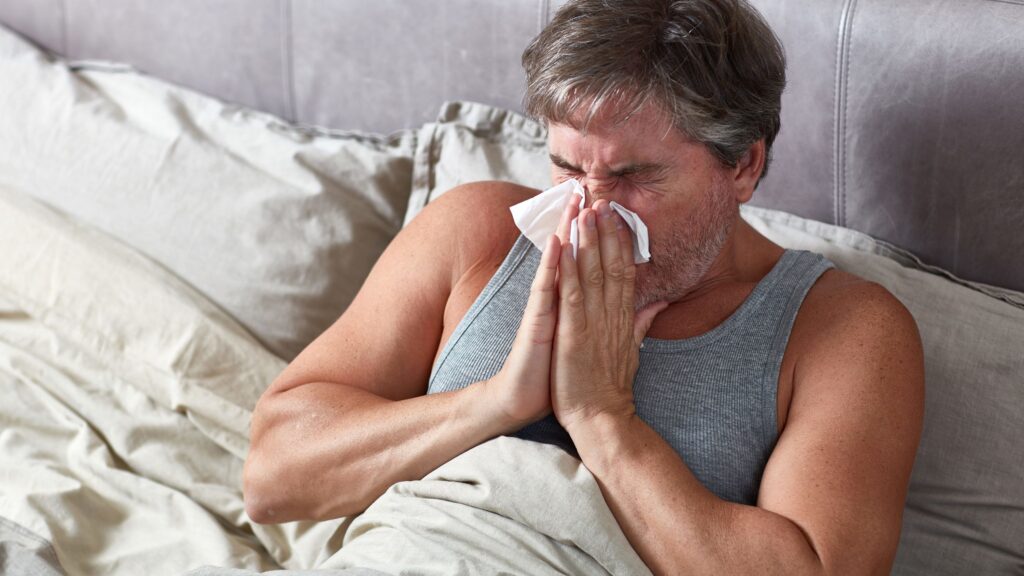flu man sneezes