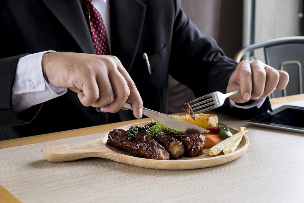 man eating meat
