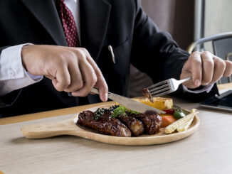 man eating meat