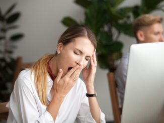 woman yawns at covid news